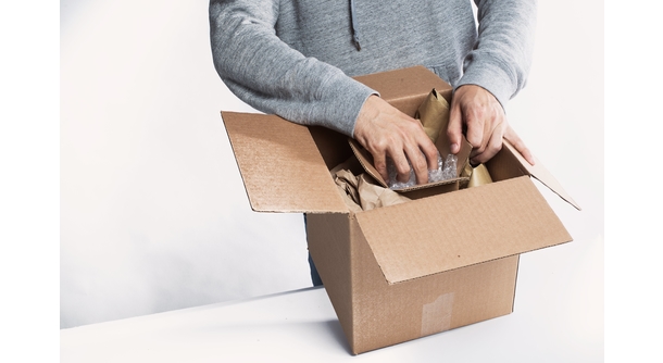 man packing a box