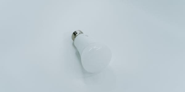 A light bulb on a white floor 