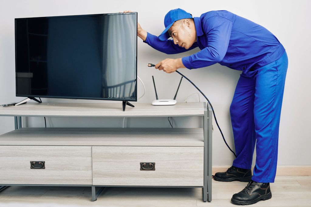A removalist person installing a TV