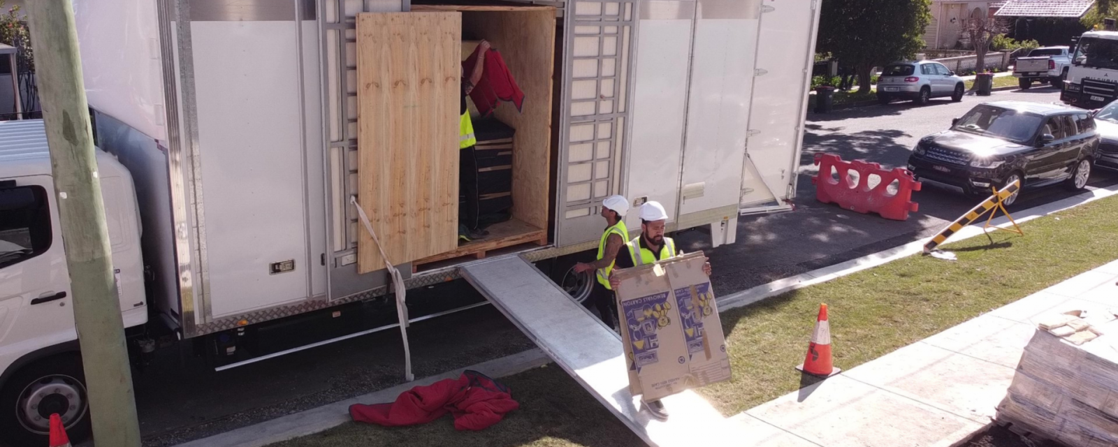 Smoothmoves crew loading a mobile storage module from a truck at a residential street in Sydney.